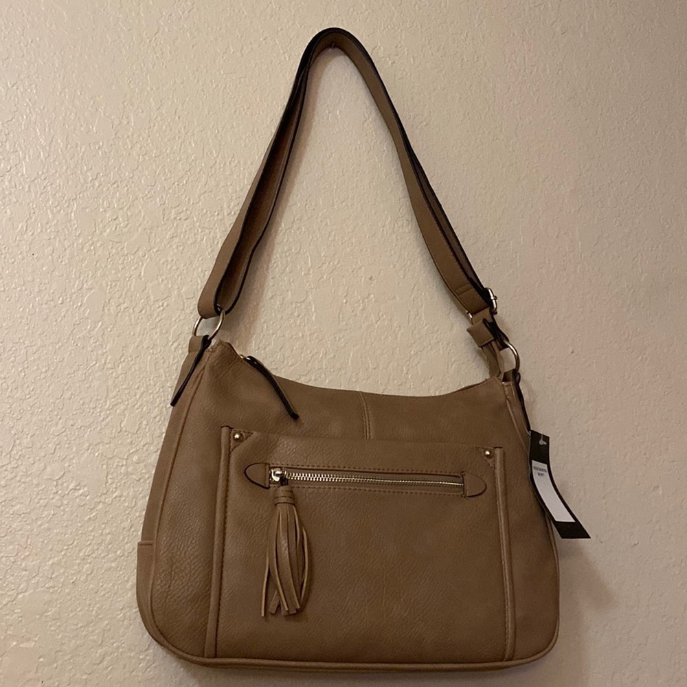 Large beige handbag adjustable strap front pocket and zipper